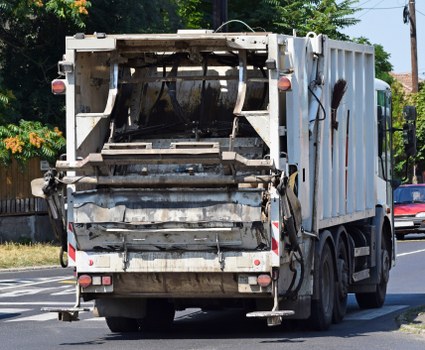 Technician assisting a local business with accessible waste collection procedures